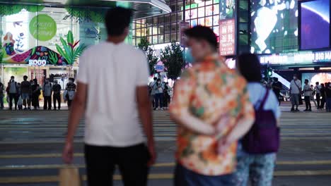 People-walking-on-the-Zebra-cross-of-night-on-one-of-the-Hongkong-streets