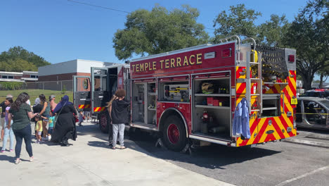 Public-Family-Event-with-Fire-Truck-at-Temple-Terrace-Fire-Station-Florida,-People-Visitors-Getting-Hands-On-Experience-with-the-Firefighting-Vehicle-Equipment