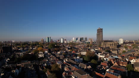 Lepelenburg-park-with-the-cityscape-of-Utrecht-in-the-background-where-the-scaffolded-church-tower-rises-above-the-urban-Dutch-city-and-financial-district-modern-central-train-station-behind