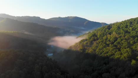 4K-Drone-Video-Flying-Above-Trees-Along-Mountain-Road-in-Smoky-Mountains-near-Asheville,-NC-on-Foggy-Morning