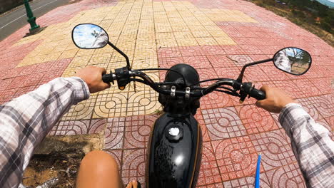 Surfer-get-on-motorbike-with-surfboard-attached-and-drive-coastal-highway,-pov