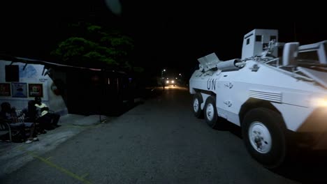 UN-patrol-the-street-with-a-armored-car-on-the-dark