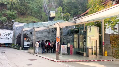 People-waiting-in-front-of-box-office-for-Ljubljana-Castle-Funicular-Railway,-Slovenia