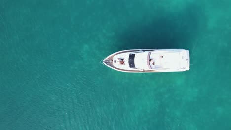 Luftaufnahme-über-Menschen,-Die-Auf-Einem-Yachtdeck-In-Der-Mittleren-Seichten,-Türkisfarbenen-Karibik-Chillen---Von-Oben-Nach-Unten,-Drohnenaufnahme