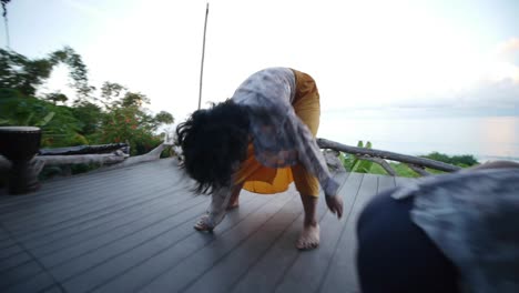Group-of-5-Asian-women-performing-improvised-ecstatic-dance-movements-in-total-freestyle,-filmed-with-roving-camera-style-and-wide-angle-lens