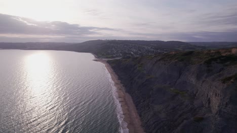 High-drone-shot-moving-backwards-along-the-cliffs-on-the-Jurassic-Coast,-Dorset,-UK