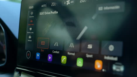 Hand-Finger-Turning-On-Eco-Drive-Mode-On-The-Car-Screen-While-Driving