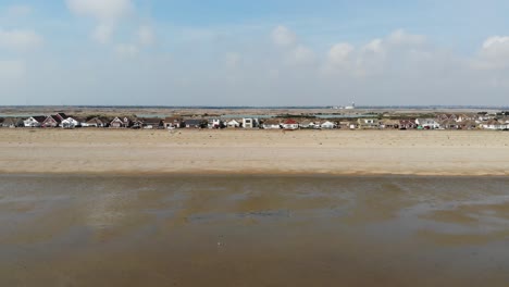 Drone-shots-of-homes-next-to-Dungeness-Beach-in-Kent,-UK-03