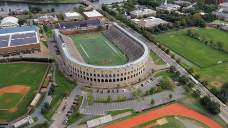 Harvard-University-Football-Stadium-Boston,-Massachusetts-Aerial-Drone-Above-Field,-Crimson-Team