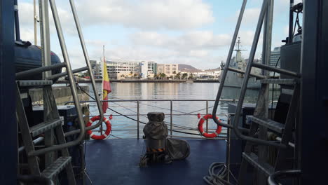 Cinematic-shot-touring-the-deck-of-the-customs-police-ship-and-where-part-of-the-city-of-Las-Palmas-and-the-Spanish-flag-are-shown