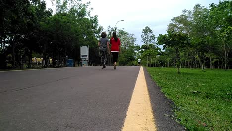 Time-Lapse-Of-People-Walking-In-Public-Park-Surrounded-With-Green-Trees,-Asuncion