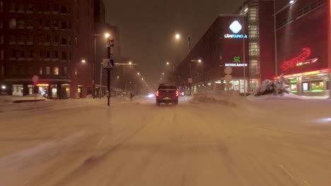 POV-driving-shot-in-a-snowstorm-in-downtown-Helsinki