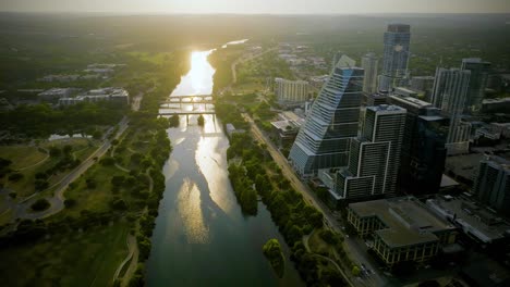 Aerial-view-of-the-Colorado-river-and-the-Google-tower,-golden-hour-in-Austin,-USA