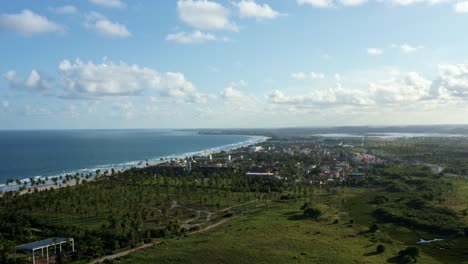 Dolly-in-aerial-drone-shot-of-the-beautiful-tropical-coastline-of-the-famous-tourist-beach-of-Porto-de-Galinhas-or-Chicken-Port-in-Pernambuco,-Brazil-on-a-warm-sunny-summer-day