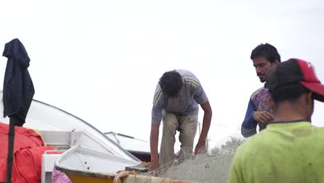 Pescador-Local-Clasificando-La-Red-De-Pesca-Dentro-Del-Barco-En-Gawadar