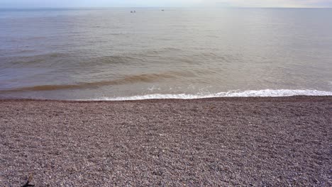 The-pebble-beach-at-Sidmouth-in-Devon-with-lapping-waves