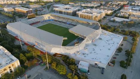 Aerial-view-around-the-sunlit-PNC-stadium-in-Houston,-USA---circling,-drone-shot
