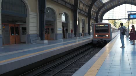 Athens-Metro-pulls-into-Piraeus-Station-while-commuters-wait