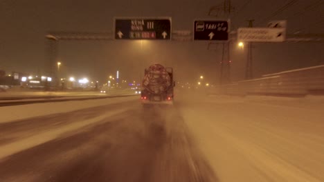 POV-driving-shot-along-a-busy-highway-in-Helsinki-with-Snow-falling
