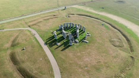 Flying-slowly-over-Stonehenge-ancient-stone-circle-Salisbury-plain-landmark-aerial-view