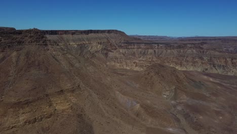 Drone-shot-of-the-Fish-River-Canyon-in-Namibia---drone-is-flying-through-the-African-gorge