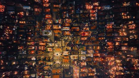 People-lighting-candles-and-decorating-tombstones,-respecting-the-dead-at-graveyards,-during-Dia-de-los-Muertos,-in-Mexico-city---Aerial-view