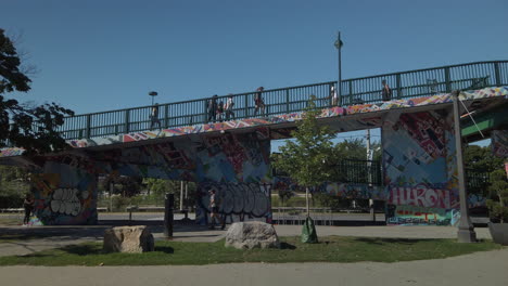 Exterior-wide-shot-of-the-busy-Roncesvalles-Pedestrian-Bridge-and-surrounding-pedestrian-and-car-traffic