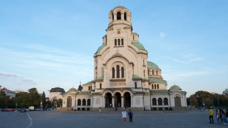 Front-Facade-of-Alexander-Nevsky-Orthodox-Church-in-Sofia,-People-Walking-on-the-Square