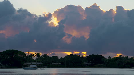Colorful-Morning-Clouds-Move-Over-Moored-Boat-In-Inlet-In-South-Florida,-U