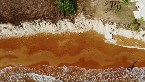 Bird's-Eye-View-Of-Red-Sand-Shore-At-Megas-Lakkos-Beach-In-Greece---aerial-drone-shot