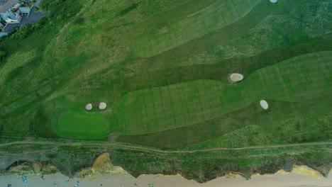 Bridport-West-bay-cliffs-above-British-seaside-golf-course-aerial-Birdseye-view-Dorset