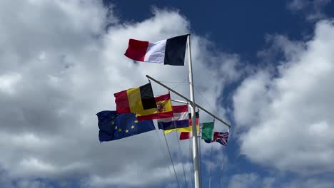 National-European-flags-on-flagpole-of-a-boat,-waved-by-wind