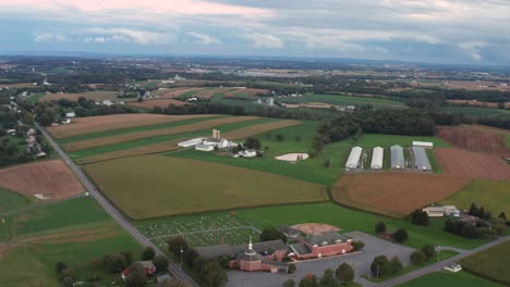 High-wide-aerial-of-rural-America-with-Christian-church,-farmland