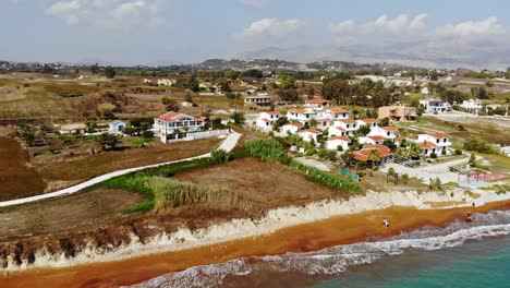 Scenic-View-Of-Coastal-Town-In-The-Coast-Of-Megas-Lakkos-Beach-In-Kefalonia-Greece---aerial-shot