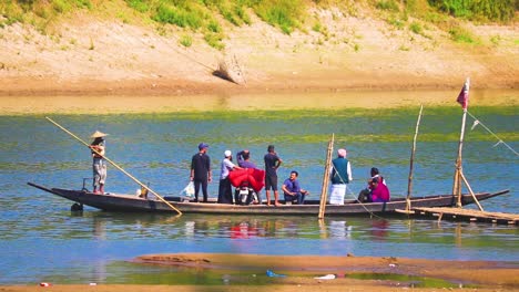 People-crossing-river-in-traditional-ghat-wooden-boat,-handheld-view