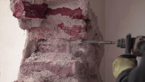 Demolition-of-a-brick-wall-with-an-electric-tool-by-a-handyman