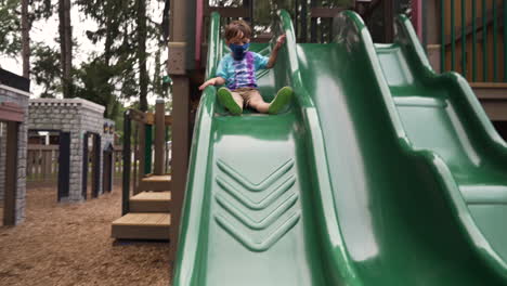 Child-playing-at-a-slide-in-the-playground-during-coronovirus-pandemic