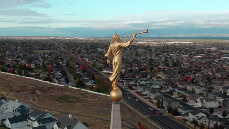 AERIAL-ORBIT-AROUND-ANGEL-MORONI-ATOP-OF-LDS-MORMON-OQUIRRH-MOUNTAIN-UTAH-TEMPLE-WITH-BEAUTIFUL-VIEW-OF-SOUTH-JORDAN-CITY-AND-THE-CLOUDY-MOUNTAINS
