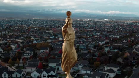 AERIAL-CLOSE-UP-WITH-EXTREMLY-DETAIL-OF-ANGEL-MORONI-WITH-HIS-TRUMPET-ATOP-OF-OQUIRRH-MOUNTAIN-UTAH-TEMPLE