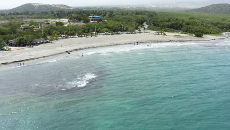 AERIAL---Beautiful-Monte-Rio-beach,-Azua,-Dominican-Republic,-forward-tilt-up