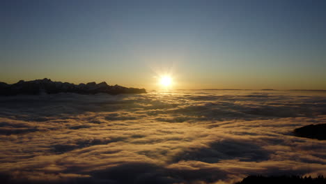 Aerial-View-Of-Sea-Of-Clouds-During-Scenic-Sunset-In-Switzerland