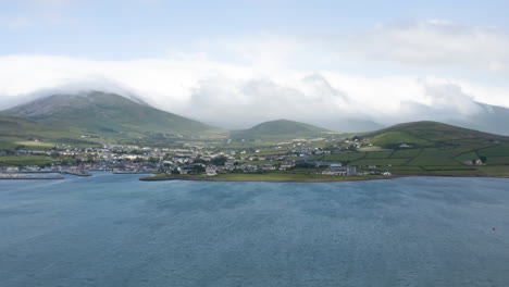 AERIAL---The-harbor-of-Dingle,-County-Kerry,-Ireland,-wide-shot-pan-right