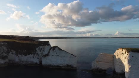 4K-Aerial-panoramic-landscape-drone-shot-of-the-cliffs-of-Old-Harry-Rocks,-in-Dorset,-on-the-English-coast-line-during-sunset