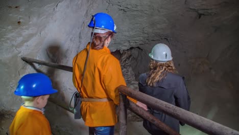 Tour-group-walk-inside-dark-mine-tunnels-in-Glancnik,-Mezica,-Slovenia