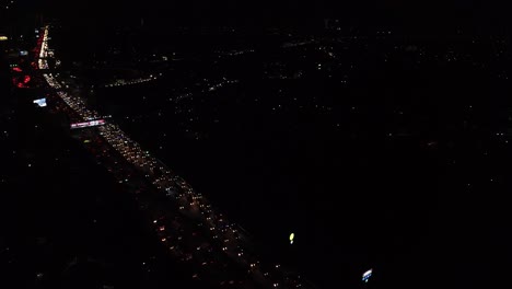 aerial-drone-shot-heavy-traffic-night-highway