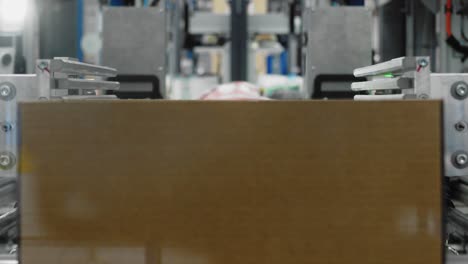 Goods-being-packaged-in-carton-boxes-by-automated-machinery