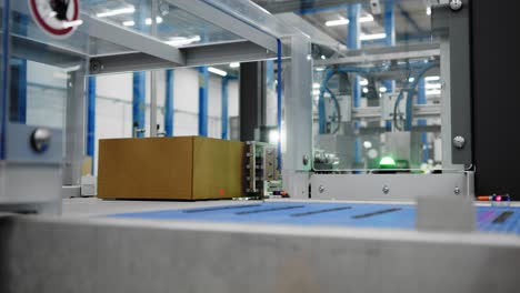 Boxes-on-conveyor-system-in-factory---automated-packaging