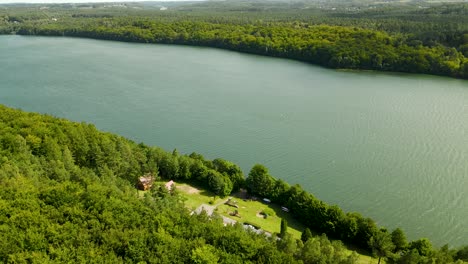 Aerial-View-Of-Lake-Radun-Amidst-The-Thick-Forest-In-Northern-Poland