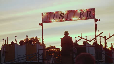 Ride-operator-stopping-Histler-carnival-ride-at-carnival,-Slow-Motion