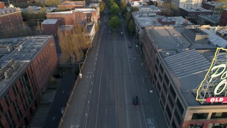 Wide-and-majestic-aerial-shot-revealing-Portland,-Oregon's-iconic-Old-Town-sign-with-empty-streets-due-to-COVID-19